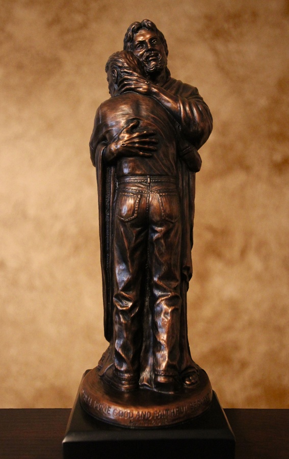 jesus embracing man sculpture